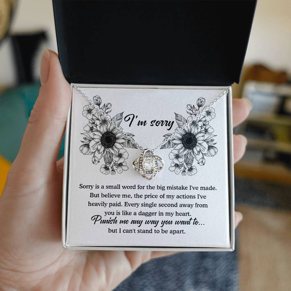 An apology filled with remorse, truly sorry for hurting you message card with love knot pendant necklace.