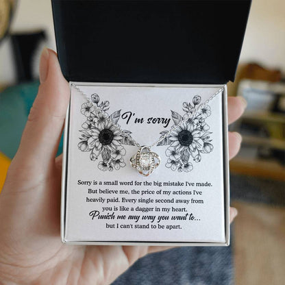 An apology filled with remorse, truly sorry for hurting you message card with love knot pendant necklace.